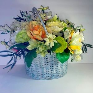 FAUX FLOWERS IN BLUE WICKER BASKET